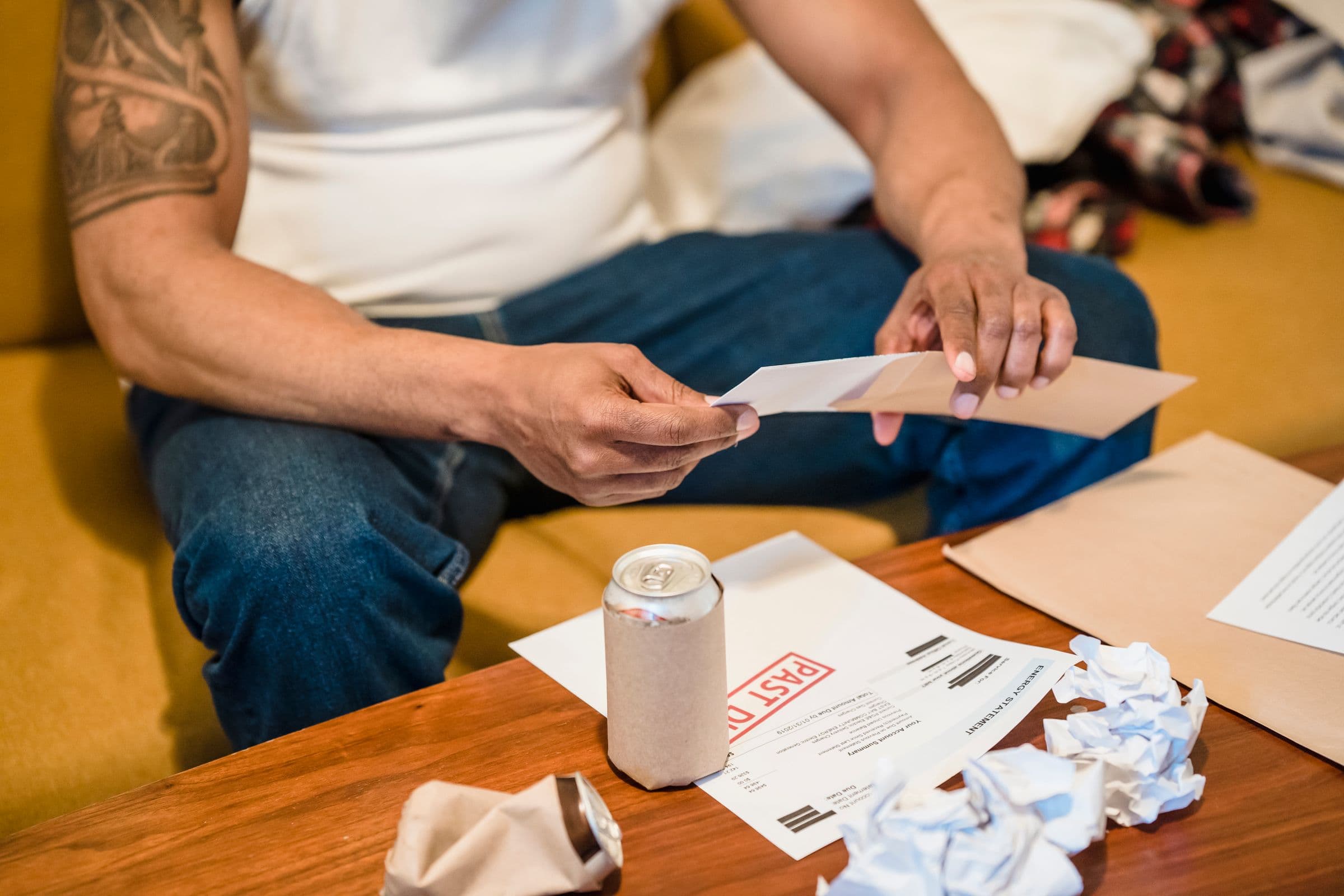 A man going through envelopes and paperwork at home
